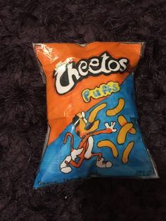 a bag of cheetos chips sitting on top of a carpet