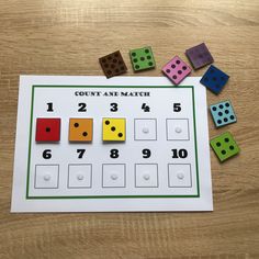 a counting game with numbers and dices on the table next to it is a sheet of paper that says count and match