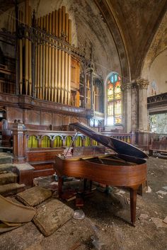 an old piano in the middle of a church