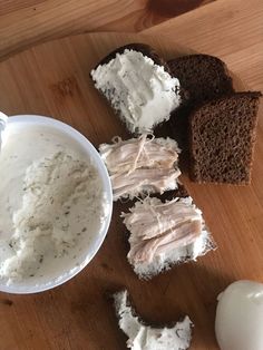 bread, cream cheese and an egg are on a cutting board next to a knife