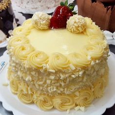 a cake with white frosting and strawberries on top