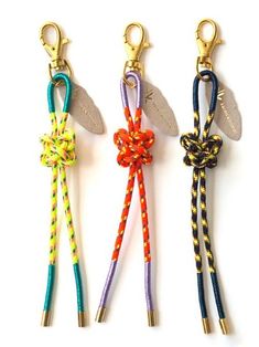 three key chains with different colored ropes attached to each other on a white background photo