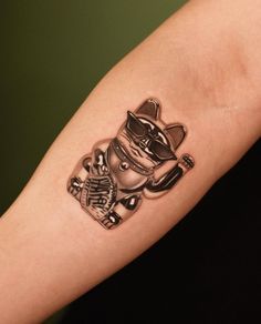 a tattoo on the arm of a person with a cat and motorcycle helmet in it