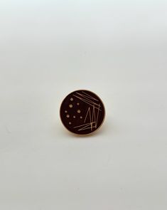 a brown and white pin with lines on it