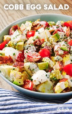 a salad with tomatoes, cucumbers and other toppings