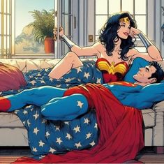 a man laying on top of a bed next to a woman in a superman costume