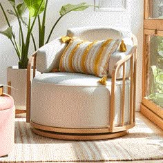 a living room with a chair and potted plant