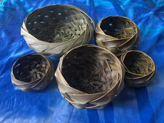 four baskets sitting on top of a blue blanket