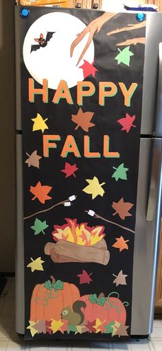 a refrigerator decorated with halloween decorations and the words happy fall