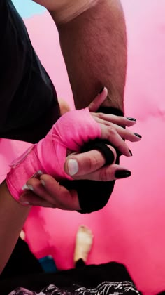 a person with pink gloves on their hands