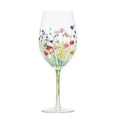 a wine glass with flowers painted on it