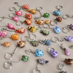 a bunch of key chains that are all different colors and sizes, with animals on them