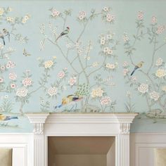 a wall with flowers and birds painted on it