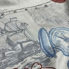 a close up view of a fabric with an image of a ship on it