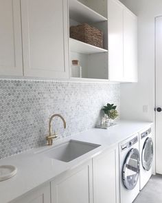 a washer and dryer in a white laundry room