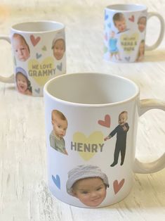 two coffee mugs with pictures of babies on them, one has a heart and the other has hearts