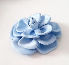 a blue flower on a white surface