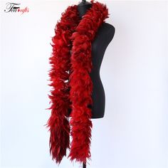 a mannequin wearing a red feather scarf