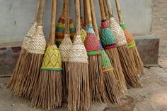 several brooms are lined up on the ground