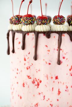 the cake is decorated with sprinkles and cherries on it's top