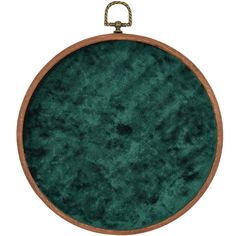 a round green rug with a wooden frame hanging from the side on a white background