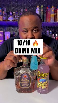 a man holding up a sign that reads 10 / 10 drink mix and two bottles in front of him