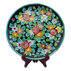 a glass plate with flowers painted on it