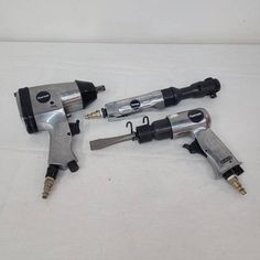 three airbrushes are laying next to each other