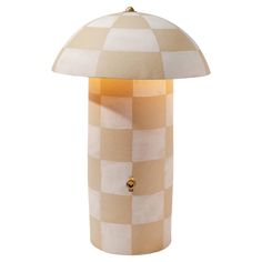 a table lamp with a checkered shade on it's base and a button at the top