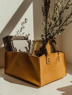 Carmel colored leather storage bin with books, glass vase, and floral arrangement Collapsible Storage, Sustainable Accessories, Collapsible Storage Bins, Leather Storage, Leather Decor, Organizing Bins, Leather Conditioner, Storage Bin, Rustic Feel