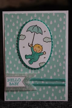 a card with a baby holding an umbrella