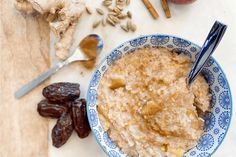 a bowl of oatmeal with raisins next to it