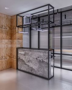 an empty room with wooden walls and glass partitions