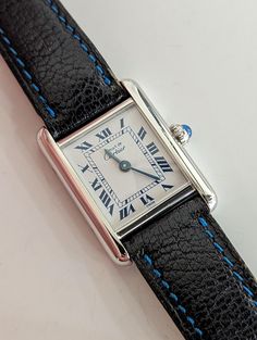 Cartier Tank Paris Wrist watch (Small size) Reference/Model: 6057002/01031 Case: 925 Silver with Rhodium plating, 20.5mm x 27.5mm Crystal: Sapphire Dial: White with Dark Blue Roman Numerals Crown: Original with blue stone Bracelet: Original leather and original Cartier buckle Movement: Quartz Circa: 2010's Box/Papers: N/N *probed, runs 100% This lovely ladies watch from Cartier is an instant classic! Originally made for the Japanese market. this beautiful timepiece has the classic Tank look we a Bracelet Original, Blue Stone Bracelet, Japanese Market, Cartier Tank, Wrist Game, Mode Inspo