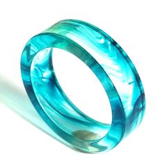 # 2021 This sea wave design raisin ring comes in size 7. Green Summer Rings, Ocean-inspired Blue Ring For Gifts, Ocean-inspired Blue Rings As Gifts, Ocean-inspired Shell Rings For Beach, Ocean Wave Ring, Unique Blue Resin Rings, Wave Ring, Sea Waves, Wave Design