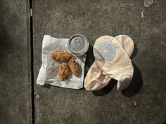 a pair of oven mitts next to an empty can and chicken nuggies