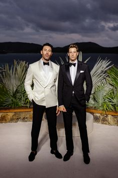 two men in tuxedos standing next to each other