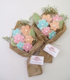 some cookies are wrapped in brown paper and have flowers on them