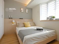 a bed sitting under a window in a bedroom