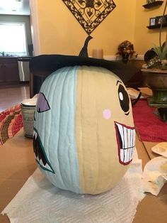 a pumpkin with a face painted on it