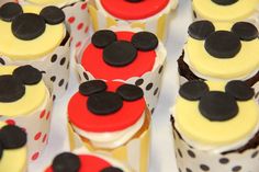 mickey mouse cupcakes with red and black frosting on them are arranged in rows