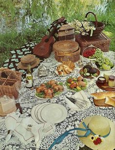 a picnic table with food and wine on it