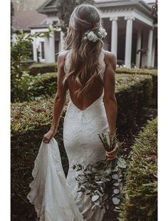 a woman in a white wedding dress holding a bouquet