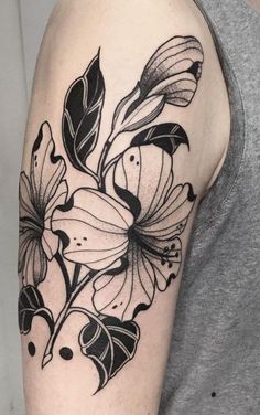 a black and white flower tattoo on the arm