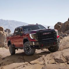 a red truck driving down a rocky road