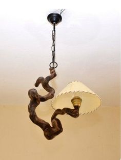 a chandelier hanging from a ceiling with a lamp in the shape of a snake