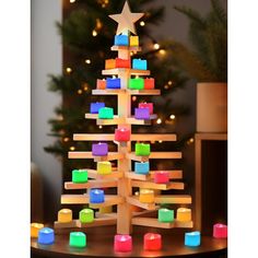 a christmas tree made out of wooden blocks with lights on the top and around it