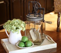 an old fashioned mason jar with ice and limes on a tray