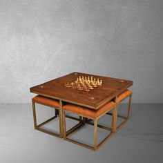 two tables with chess pieces on them sitting next to each other in front of a gray wall