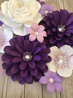 purple and white paper flowers on wooden table